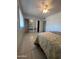 This bedroom has tile floors, ceiling fan and mirrored closet doors at 10402 N Balboa Dr, Sun City, AZ 85351