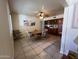 Open dining area with a view of the built-in shelving and into the kitchen and living areas at 10402 N Balboa Dr, Sun City, AZ 85351