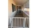 Covered front porch with secure access gate, security door, and tile flooring at 10402 N Balboa Dr, Sun City, AZ 85351