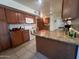 Well-equipped kitchen with wood cabinets, granite countertops, and modern appliances at 10402 N Balboa Dr, Sun City, AZ 85351