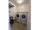 Functional laundry room featuring a washer, dryer, and plenty of storage space at 10402 N Balboa Dr, Sun City, AZ 85351