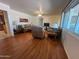 Bright living room with hardwood floors and ample seating and window at 10402 N Balboa Dr, Sun City, AZ 85351