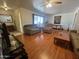 Inviting living room with hardwood floors, ceiling fan and a large window for natural light at 10402 N Balboa Dr, Sun City, AZ 85351