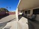 A covered patio with chairs and view of a gravel backyard and block wall at 10402 N Balboa Dr, Sun City, AZ 85351