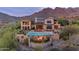 Breathtaking backyard with a pool, outdoor seating, and incredible views of the surrounding landscape at 10935 E Grandview Way, Scottsdale, AZ 85255