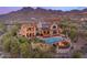Stunning backyard featuring a pool, fire pit, mountain views, and lush desert landscaping at 10935 E Grandview Way, Scottsdale, AZ 85255