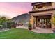 Outdoor oasis with a cozy patio area, lush landscaping, and mountain views at 10935 E Grandview Way, Scottsdale, AZ 85255