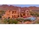 Beautiful backyard featuring a pool, lounge chairs, mountain views, and lush landscaping at 10935 E Grandview Way, Scottsdale, AZ 85255