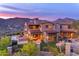 Expansive backyard featuring a pool, outdoor kitchen, and lush landscaping, perfect for entertaining at 10935 E Grandview Way, Scottsdale, AZ 85255