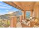 Inviting outdoor balcony with seating and picturesque view of desert landscape and sunrise at 10935 E Grandview Way, Scottsdale, AZ 85255