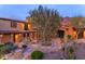 Beautiful home boasting a well-manicured yard, stone pathways, and a charming entrance at 10935 E Grandview Way, Scottsdale, AZ 85255