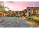 Elegant, multi-story home featuring a stone driveway, manicured landscaping and architectural details at 10935 E Grandview Way, Scottsdale, AZ 85255