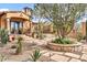 Charming home featuring manicured landscaping, stone pathways, and a welcoming entrance at 10935 E Grandview Way, Scottsdale, AZ 85255
