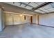 Spacious garage featuring epoxy floor and ample storage, with air conditioning at 10935 E Grandview Way, Scottsdale, AZ 85255