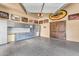 Spacious garage with storage cabinets, work bench and a large double door entrance at 10935 E Grandview Way, Scottsdale, AZ 85255