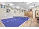 Game room with ping pong table, seating area, and wood paneled walls with athletic themed pictures at 10935 E Grandview Way, Scottsdale, AZ 85255