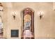 Hallway view with stone accent walls and decorative sconces at 10935 E Grandview Way, Scottsdale, AZ 85255