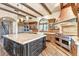 Spacious kitchen with a large island, wooden beams, and stainless steel appliances at 10935 E Grandview Way, Scottsdale, AZ 85255
