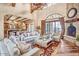 Spacious living room featuring a high vaulted ceiling, fireplace and multiple seating areas at 10935 E Grandview Way, Scottsdale, AZ 85255