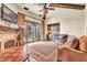 Bright and airy living room with a fireplace, hardwood floors, and access to an outdoor patio at 10935 E Grandview Way, Scottsdale, AZ 85255