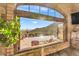 Relaxing view of patio, mountains and pool from stone walled seating area at 10935 E Grandview Way, Scottsdale, AZ 85255