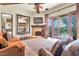 Spacious living room with a cozy fireplace, hardwood floors, and access to an outdoor patio at 10935 E Grandview Way, Scottsdale, AZ 85255