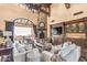 Spacious living room with a stone fireplace, vaulted ceiling and comfortable seating at 10935 E Grandview Way, Scottsdale, AZ 85255