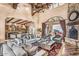 Open concept living room with stone fireplace, high ceilings, and seamless indoor/outdoor living at 10935 E Grandview Way, Scottsdale, AZ 85255