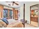Comfortable bedroom featuring hardwood floors and a spa-like ensuite bathroom at 10935 E Grandview Way, Scottsdale, AZ 85255
