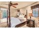 Inviting bedroom with a four-poster bed, soft lighting, and warm, neutral tones at 10935 E Grandview Way, Scottsdale, AZ 85255