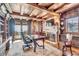 Stylish office with wood accents, fireplace, built-in shelving, and exterior view at 10935 E Grandview Way, Scottsdale, AZ 85255