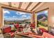 Inviting patio with comfortable seating area, offering panoramic desert and mountain views at 10935 E Grandview Way, Scottsdale, AZ 85255