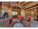 Inviting stone patio with mountain views features comfortable seating and a cozy fireplace at 10935 E Grandview Way, Scottsdale, AZ 85255