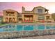 Expansive stone pool overlooking landscaped backyard, accented by a stone house and desert views at 10935 E Grandview Way, Scottsdale, AZ 85255