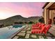 Inviting pool with lounge chairs offering breathtaking views of the mountains at 10935 E Grandview Way, Scottsdale, AZ 85255