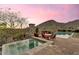 Relaxing pool and spa area surrounded by comfortable seating and views of the surrounding landscape at 10935 E Grandview Way, Scottsdale, AZ 85255