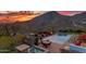 Stunning backyard featuring a pool, spa, built-in grill, fire pit, and panoramic mountain views at 10935 E Grandview Way, Scottsdale, AZ 85255