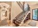 Elegant staircase with iron railings and decorative tile risers at 10935 E Grandview Way, Scottsdale, AZ 85255