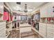 Spacious walk-in closet with custom shelving, drawers, and center island for storage at 10935 E Grandview Way, Scottsdale, AZ 85255