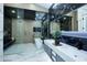A spa-like bathroom with marble accents, a soaking tub, and sleek fixtures at 11578 N 80Th Pl, Scottsdale, AZ 85260