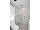 Beautiful bathroom with marble shower, glass door, and herringbone tile flooring creating a spa-like atmosphere at 11578 N 80Th Pl, Scottsdale, AZ 85260