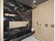 Luxurious walk-in shower with a rainfall shower head and beautiful black marble and gold tile at 11578 N 80Th Pl, Scottsdale, AZ 85260
