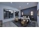 Stylish bedroom with large windows, accent wall, sitting area, and plush rug at 11578 N 80Th Pl, Scottsdale, AZ 85260