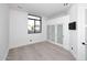 Bright bedroom with white walls, modern window, light wood floors, and closet with frosted sliding doors at 11578 N 80Th Pl, Scottsdale, AZ 85260