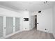 Bright bedroom with white walls, light wood floors, closet with frosted sliding doors and access to hallway at 11578 N 80Th Pl, Scottsdale, AZ 85260