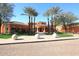 Club entrance with a circular facade, trimmed lawn and symmetrical palm tree placement at 11578 N 80Th Pl, Scottsdale, AZ 85260