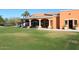 Clubhouse with large patio area and seating overlooking a manicured lawn at 11578 N 80Th Pl, Scottsdale, AZ 85260