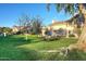 Serene community green space with a bench, mature trees, and well-maintained landscaping on a sunny day at 11578 N 80Th Pl, Scottsdale, AZ 85260