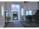 A well-lit modern entrance featuring a sleek black front door, manicured landscaping, and contemporary exterior lighting at 11578 N 80Th Pl, Scottsdale, AZ 85260