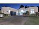 Modern home exterior featuring manicured landscaping, a paved driveway, and a black garage door at twilight at 11578 N 80Th Pl, Scottsdale, AZ 85260